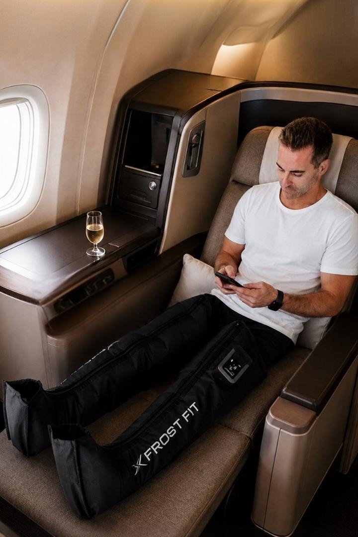 Traveler wearing Recovery Wraps compression boots